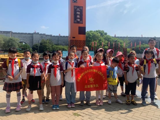 A group of children holding a sign&#xA;&#xA;Description automatically generated with medium confidence